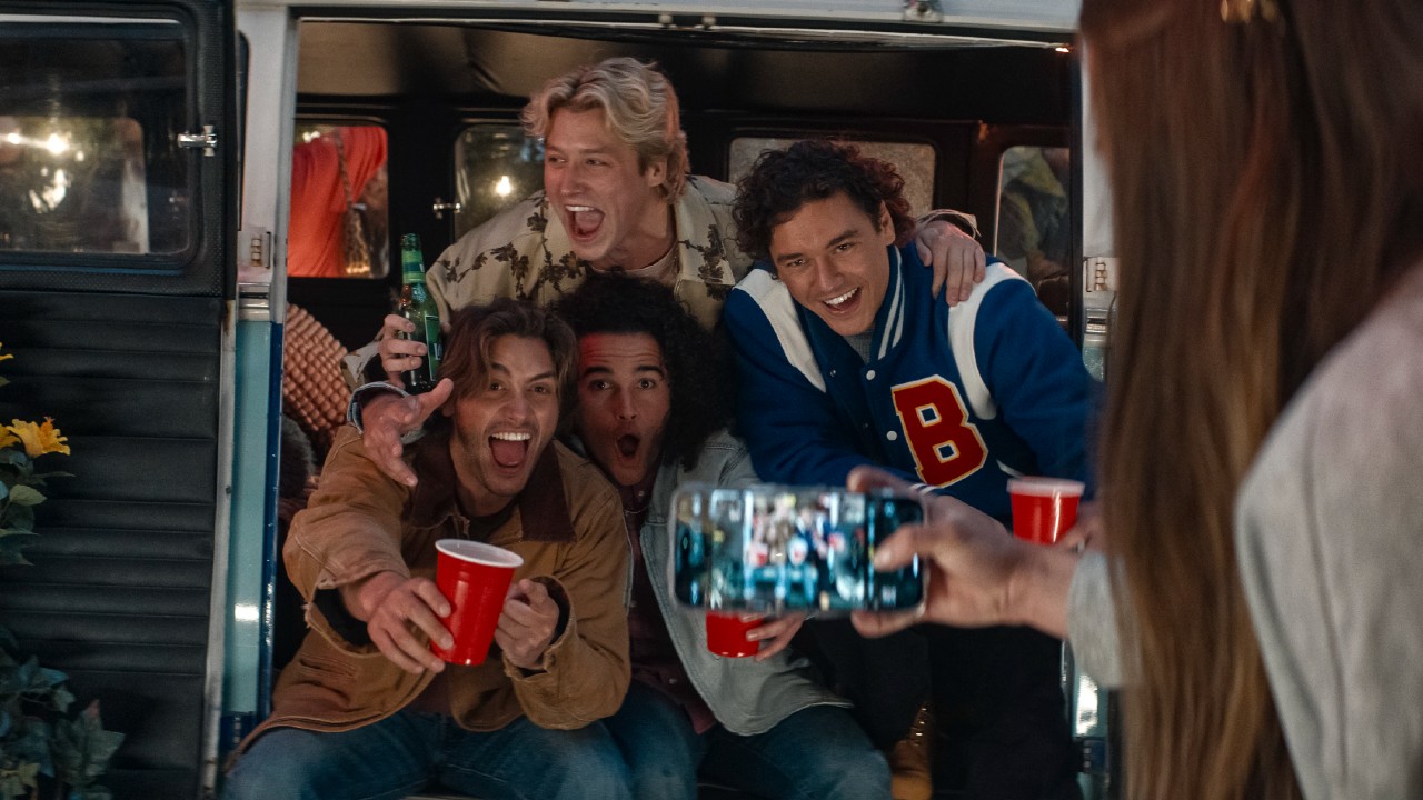 From left to right: John Logan, John Tucker and Garrett Graham smiling and sitting together and Dean DiLaurentes standing above them with his arms around their shoulders.