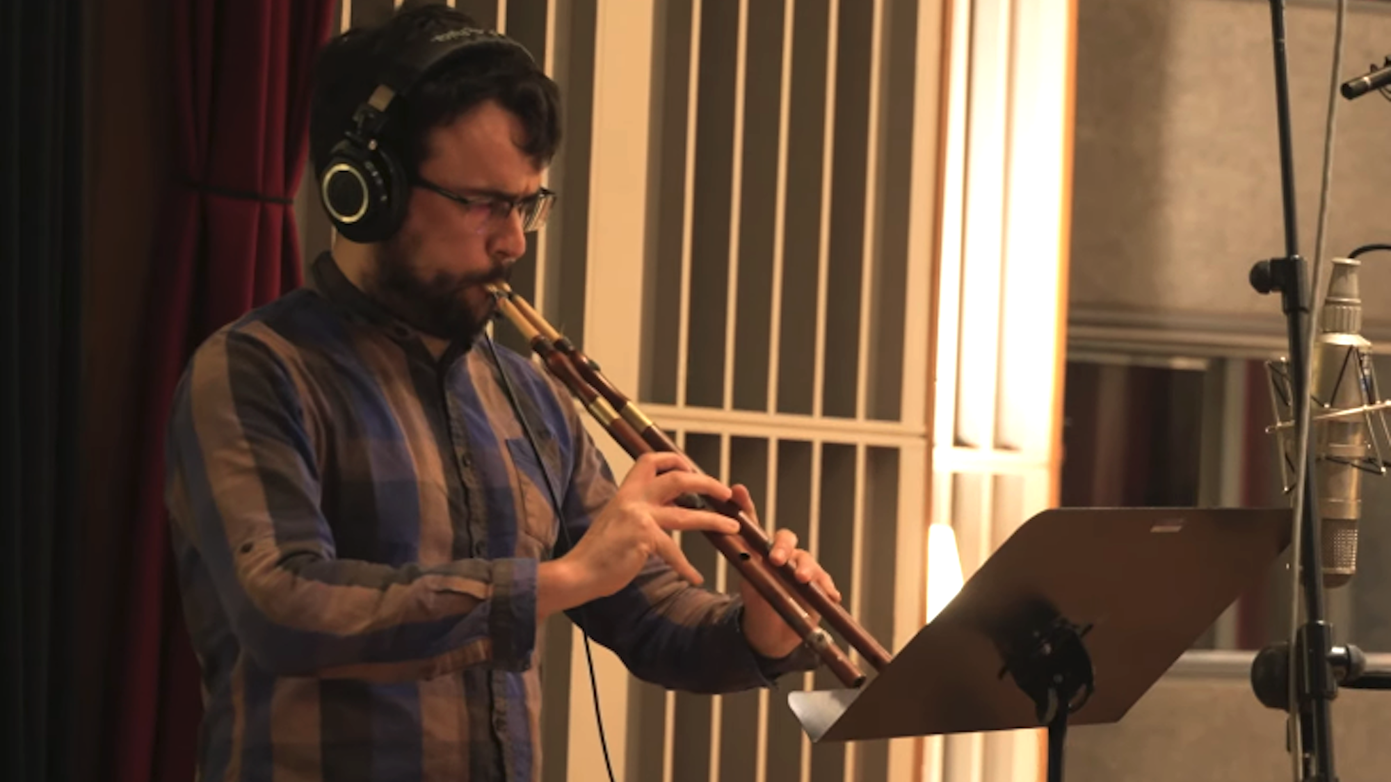 musician on a aulos while making The Odyssey score