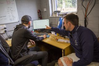 Dan Paker and Jake Field checking on the status of the golf course via a computer