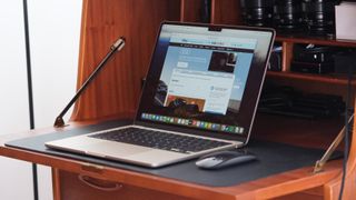 Apple MacBook Air sitting on a wooden desk