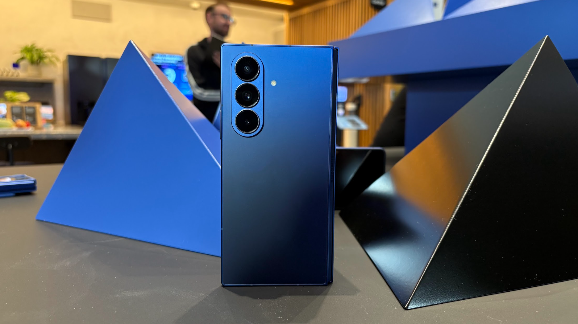 Samsung Galaxy Z Fold 7 in Shadow Blue on a table with pyramids in the background