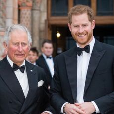 Prince Harry and King Charles wearing tuxedos standing next to each other