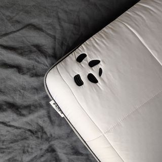 The Panda Hybrid Bamboo Pillow being tested on a grey linen duvet cover