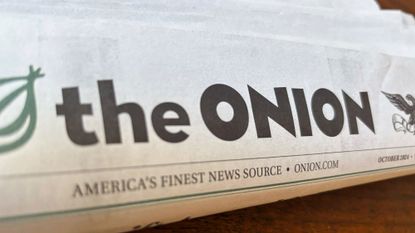 A copy of The Onion newspaper is displayed.