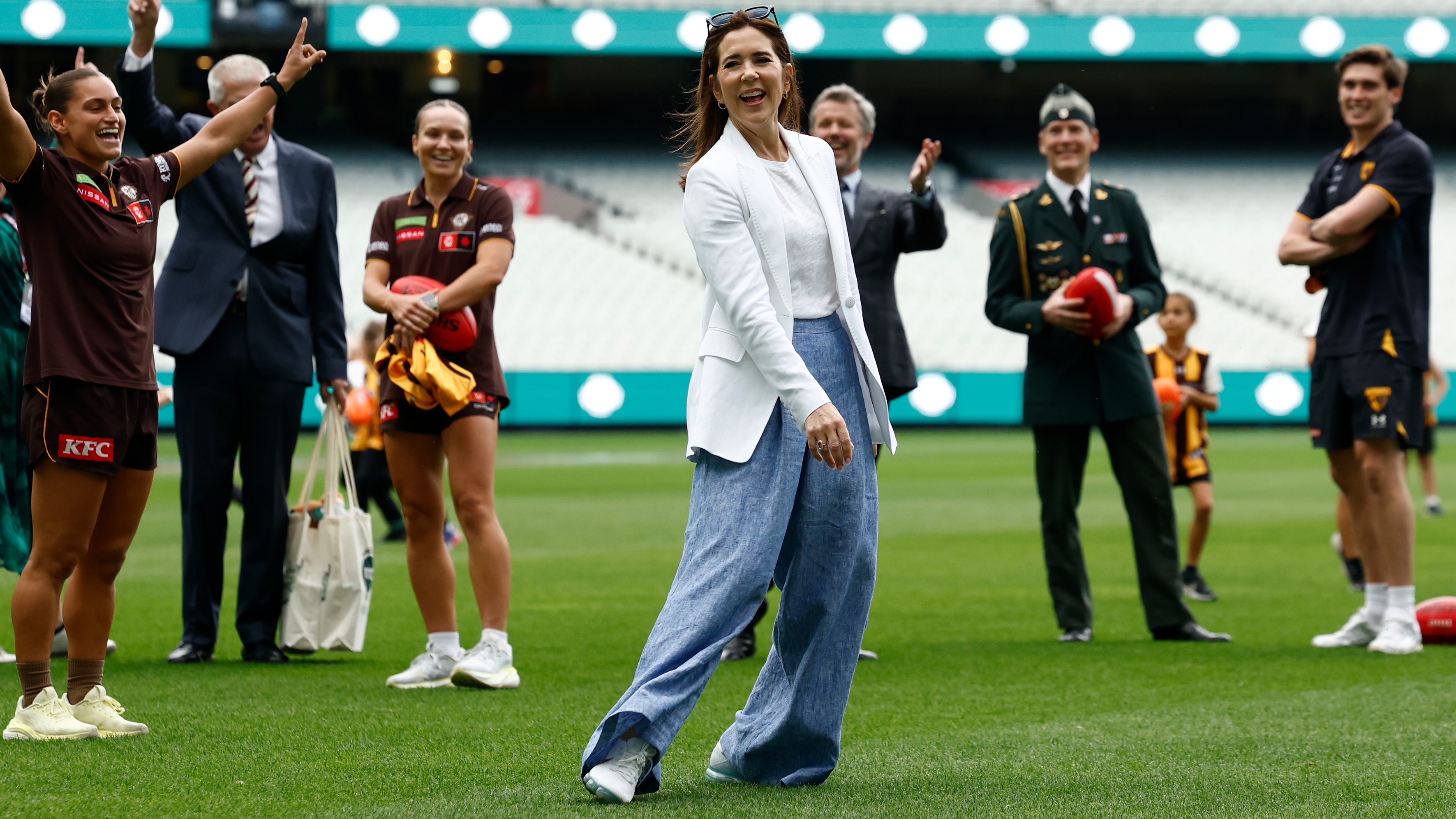 Queen Mary of Denmark celebrates after kicking a goal during the Danish Royal visit of the MCG at the Melbourne Cricket Ground on March 17, 2026