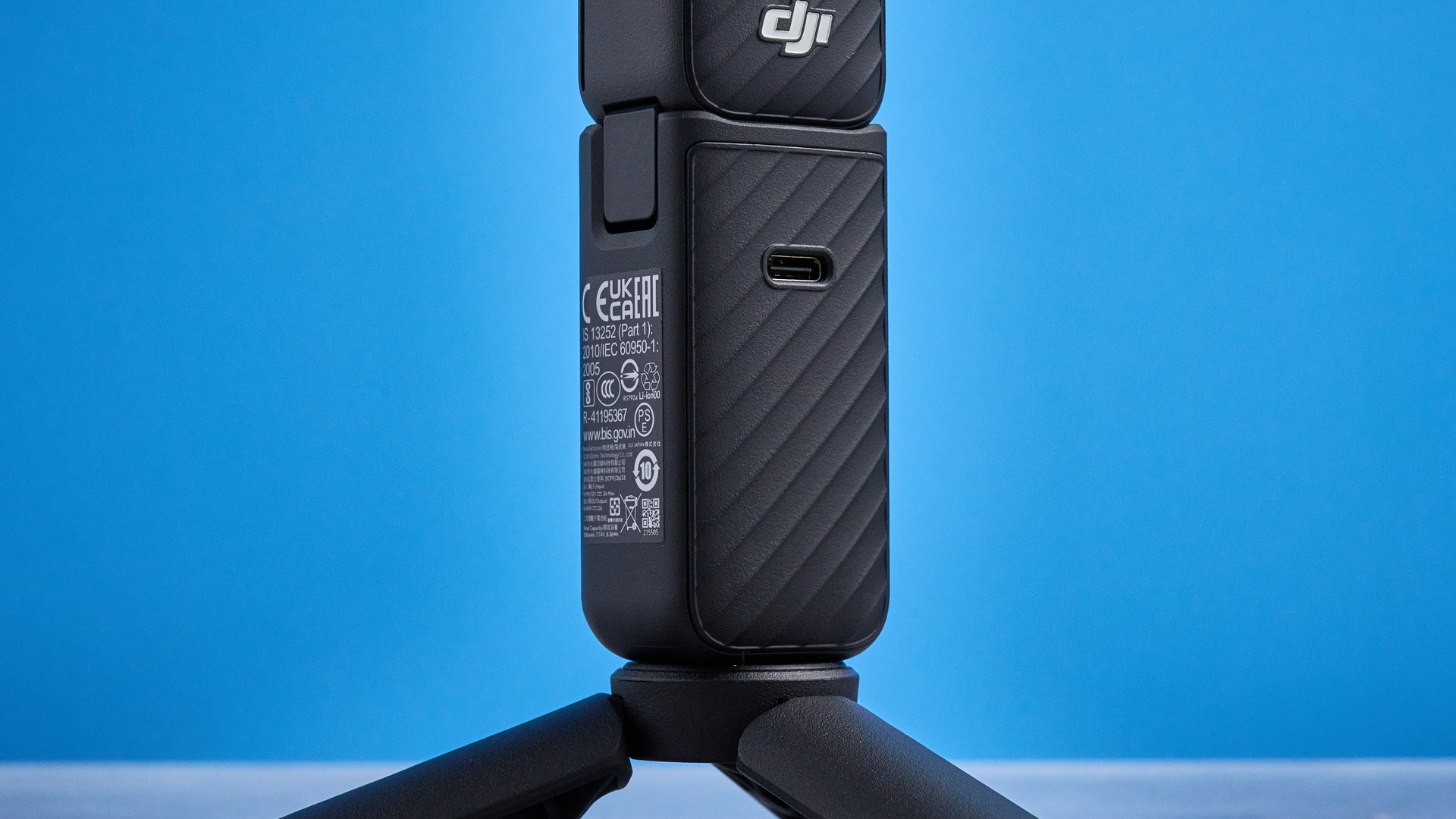 DJI Osmo Pocket 4 against a blue background