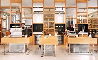 Set up on their own mini-stands, the baristas meticulously prepare their coffee facing the entrance door