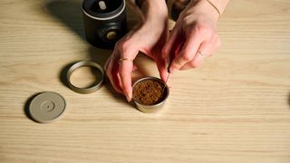 A WDT tool being used to disperse clumps within the Wacaco Picopresso basket