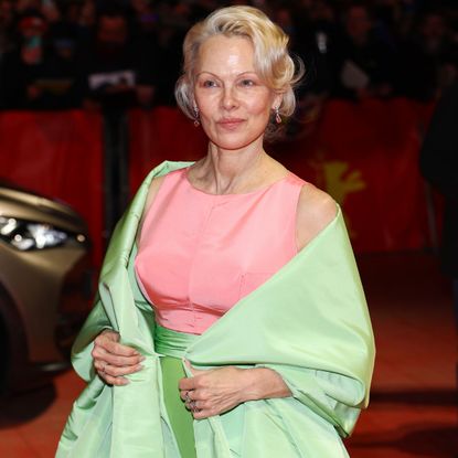 pamela anderson wears a pink and green look at the berlinale red carpet