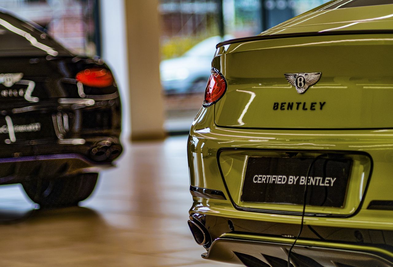 Rear of a yellow Bentley car in a showroom, taken with the Alice Camera