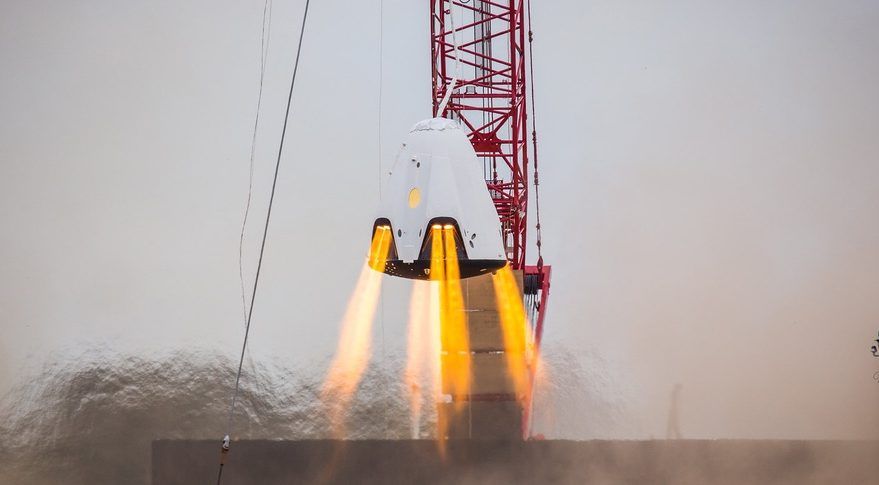 A SpaceX Crew Dragon spacecraft testing its SuperDraco thrusters. SpaceX said July 15 that an accident nearly three months earlier that destroyed a Crew Dragon spacecraft during testing was likely caused by a faulty valve in the SuperDraco propulsion system.