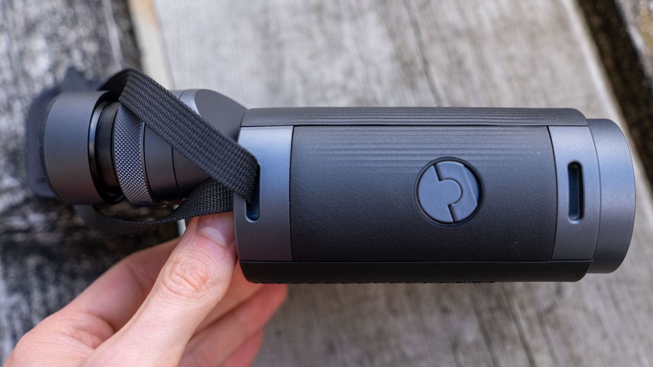 A side view of the Fujifilm Techno-Stabi TS-L 1640 image-stabilized binoculars with wooden planks in the background.