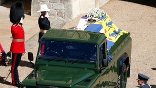 Members of the armed forces pay tribute to the coffin of Britain's Prince Philip, Duke of Edinburgh in the quadrangle ahead of the ceremonial funeral procession of to St George's Chapel in Windsor Castle in Windsor