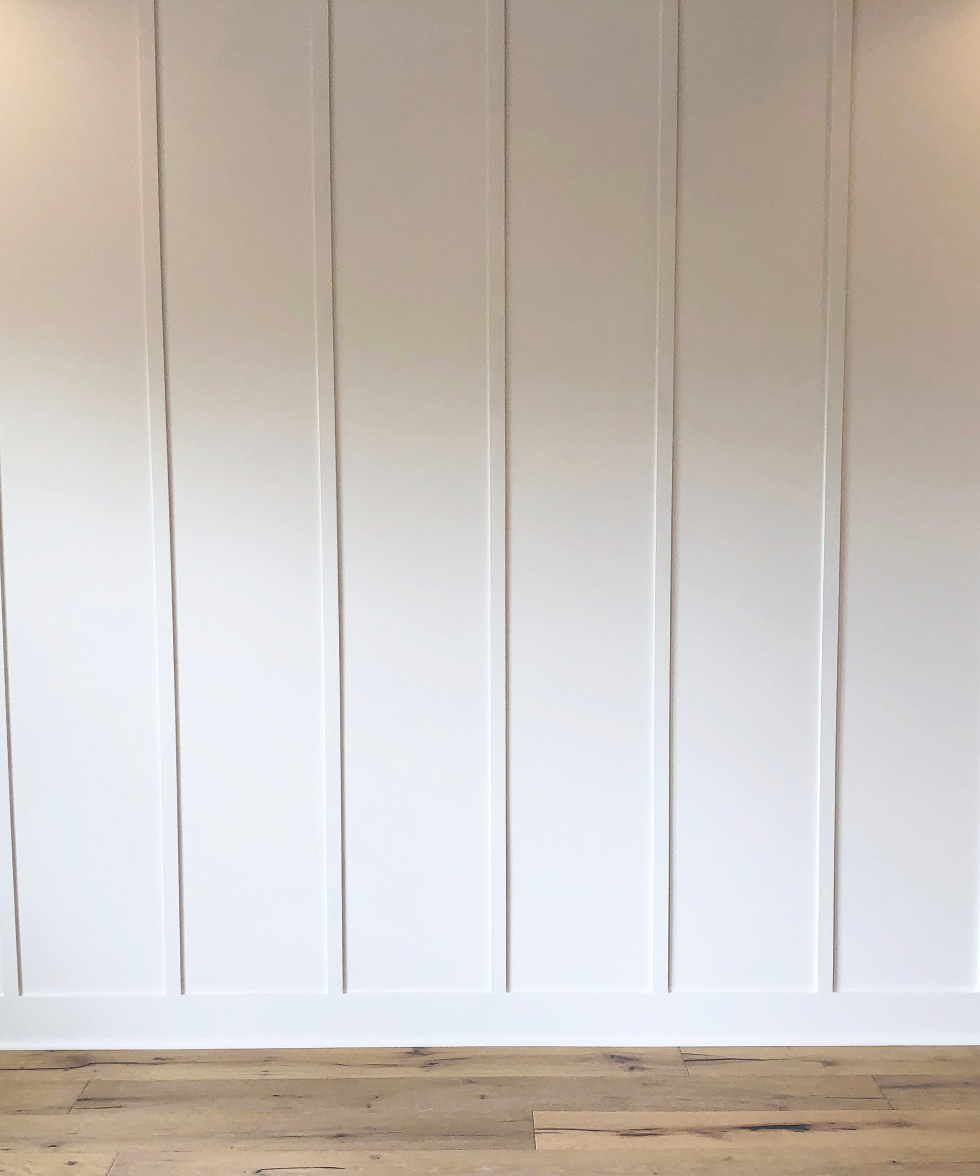 Cream board and battern panelling above a wooden floor