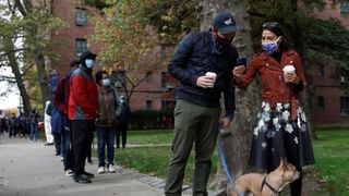 2d7w3f0 congresswoman alexandria ocasio cortez r stands in line with her partner riley roberts and her french bulldog named deco as she waits to vote early at a polling station in the bronx, new york city, us, october 25, 2020 reutersandrew kelly