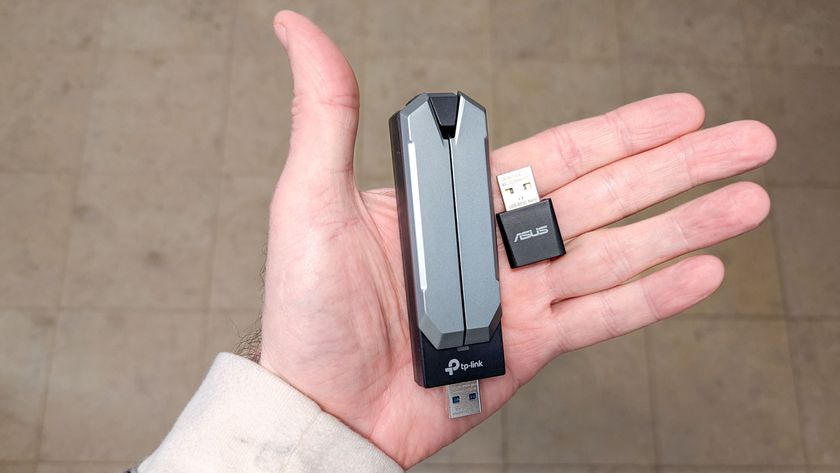 Two Wi-Fi 7 USB adapters in hand
