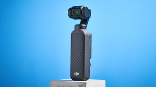 DJI Osmo Pocket 4 against a blue background