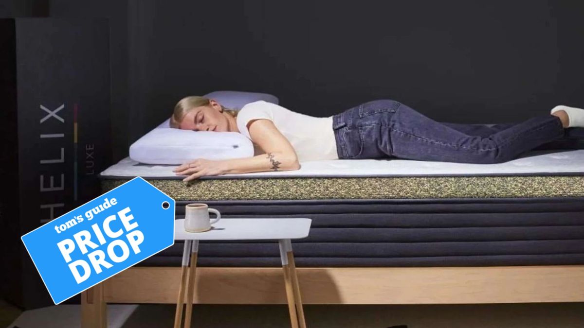 The image shows a woman laying on her stomach on the Helix Dawn Luxe mattress with a Tom&#039;s Guide price drop logp on the left