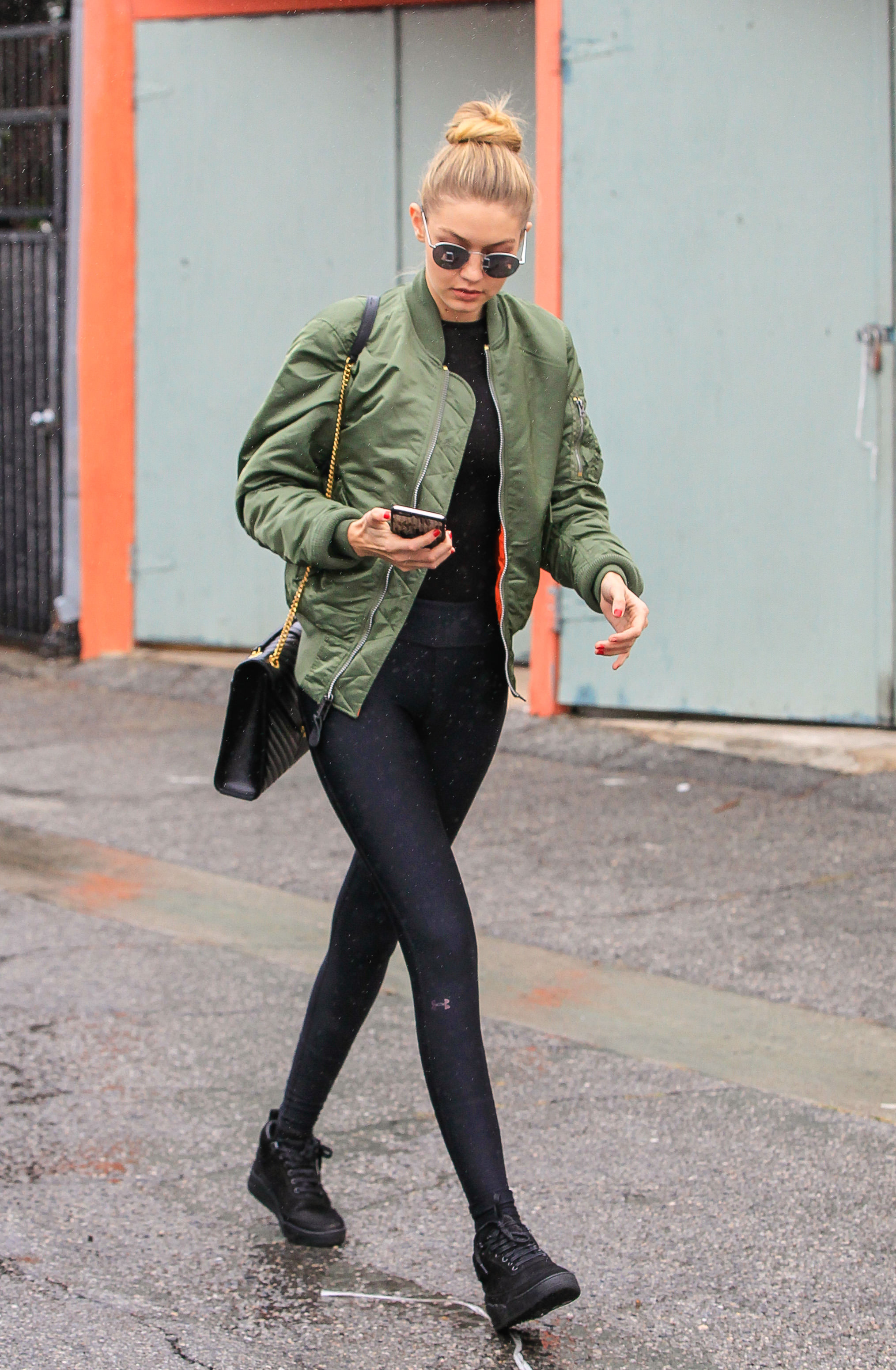 An image of Gigi Hadid wearing a green military jacket out in 2015.