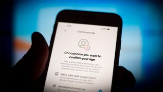 A person holding a cellphone asking the user to confirm their age