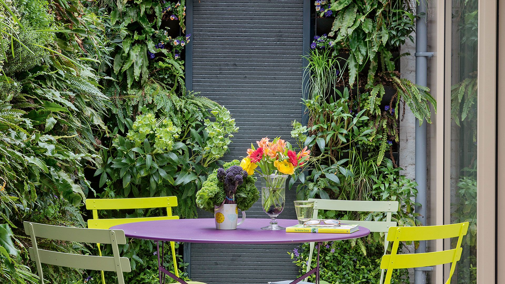 courtyard garden with vertical planting living walls and bistro table set