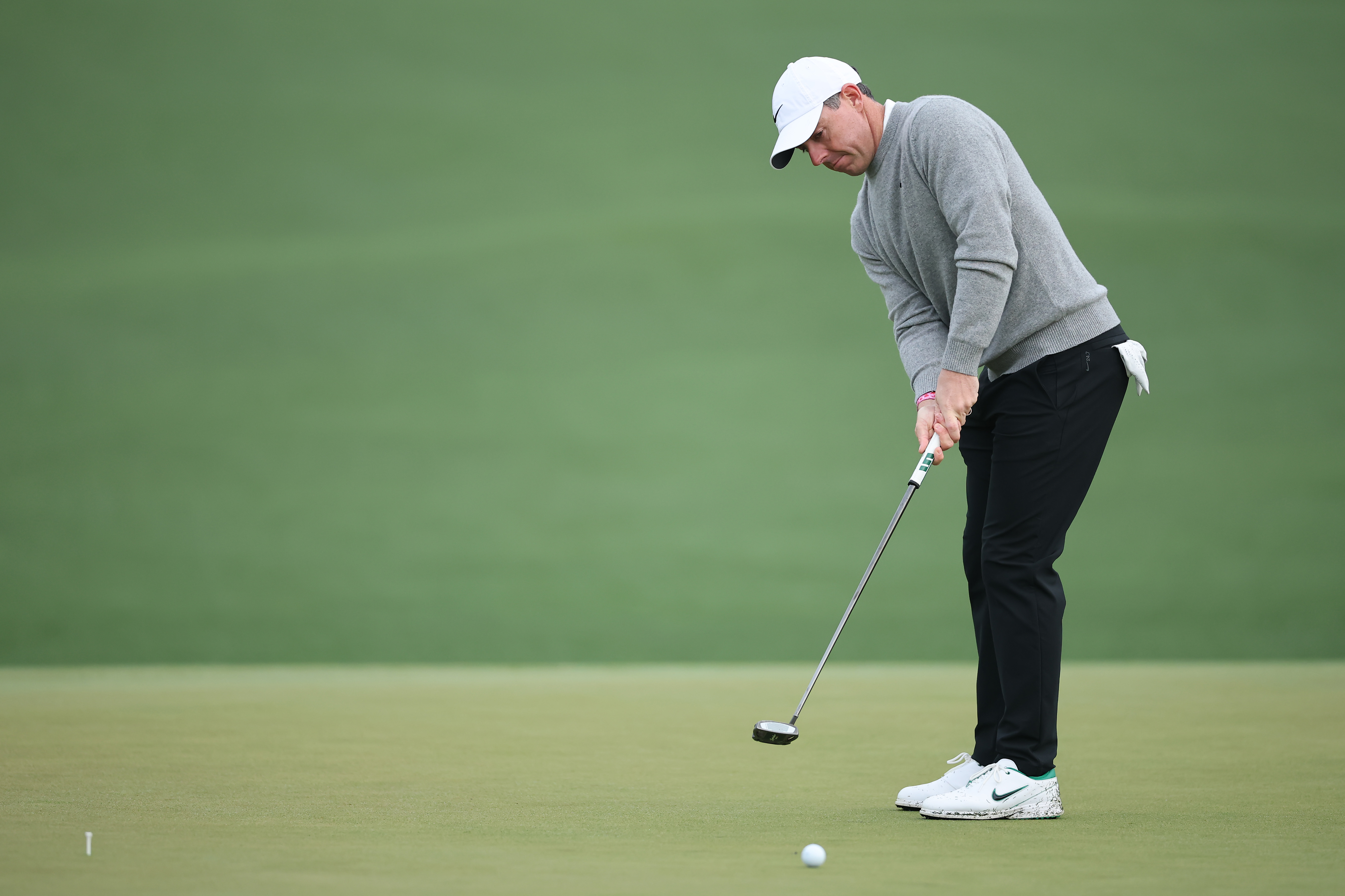 Rory McIlroy hits a putt on the second hole green during a practice round prior to the 2026 Masters Tournament at Augusta National Golf Club