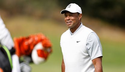 Tiger Woods walks and smiles