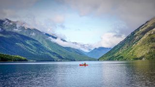 Person kayaking in Nelson Lakes in New Zealand