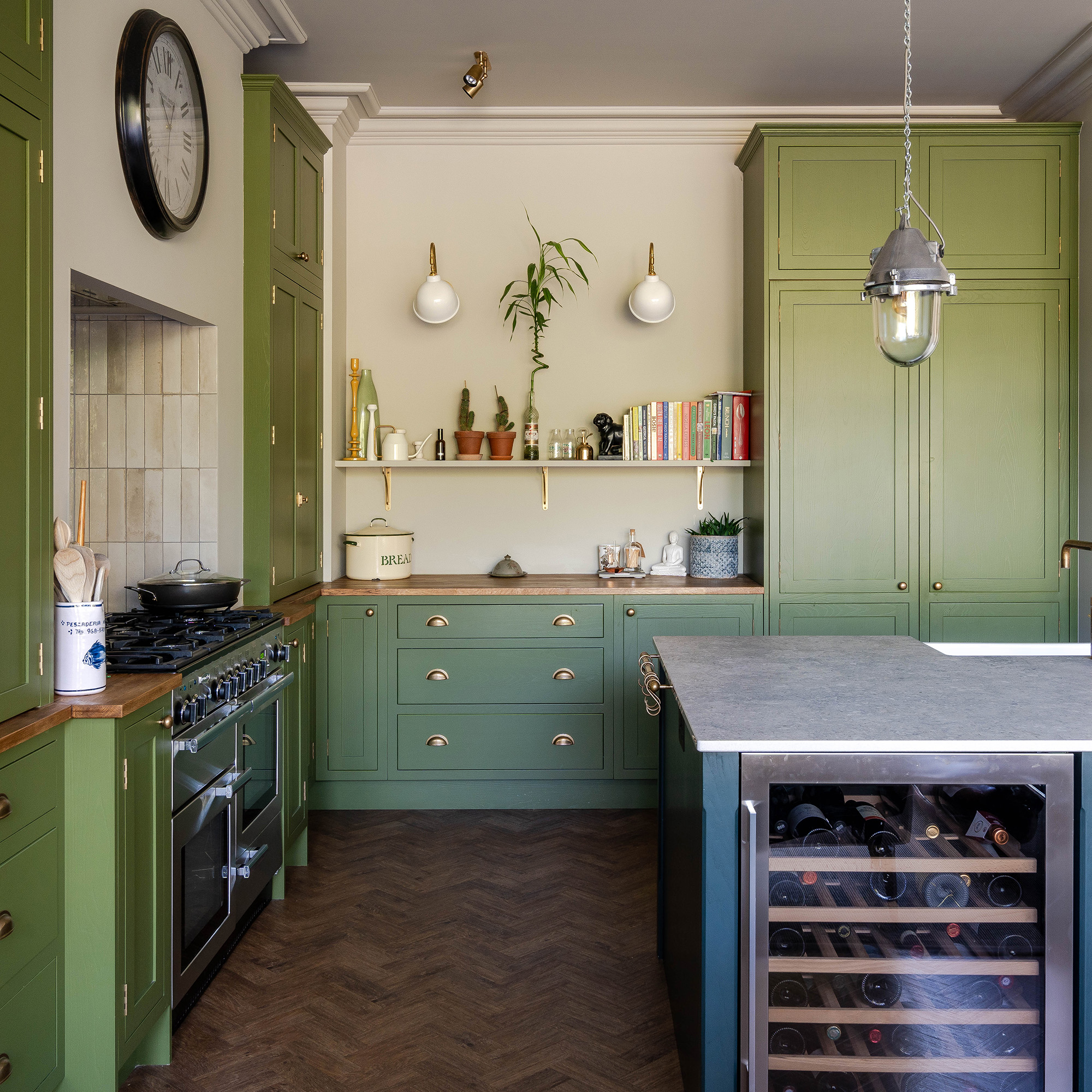 green open plan kitchen with blue island with metal worktop and wooden parquet floors