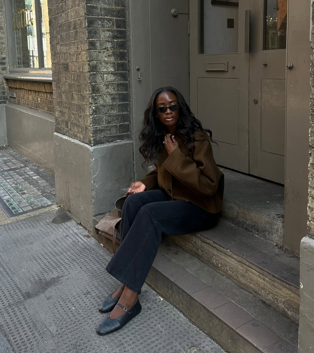 Liv in a wool coat and black jeans and flats