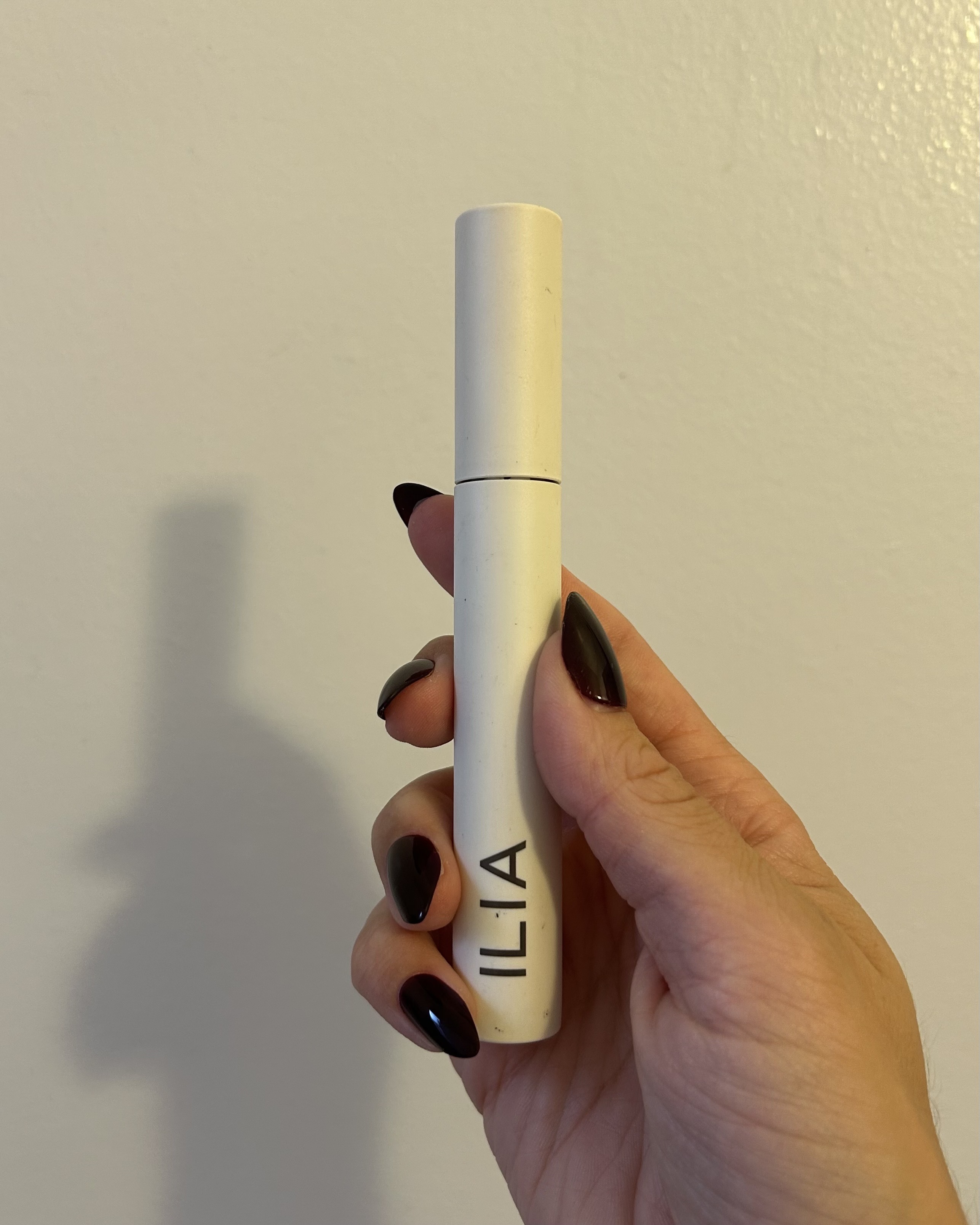 Alyssa Brascia holding the Ilia Limitless Lash Mascara in Before Dawn.