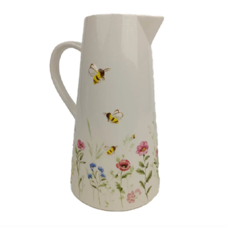 A white jug vase with floral details