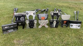 Selection of putters lying on the ground