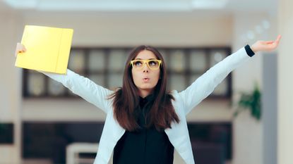 A young woman happily leaves an office.