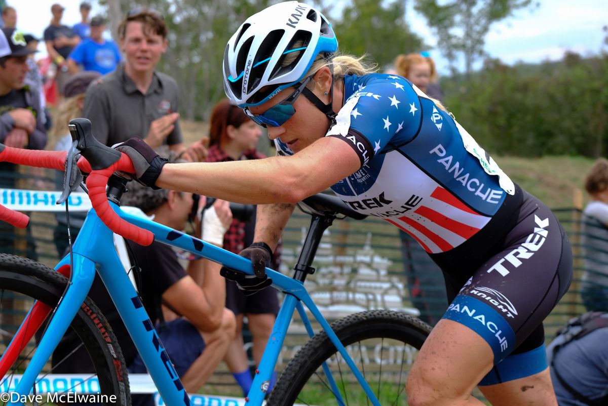 USA Champion Katie Compton (Trek Panache) pushing her bike during the second lap