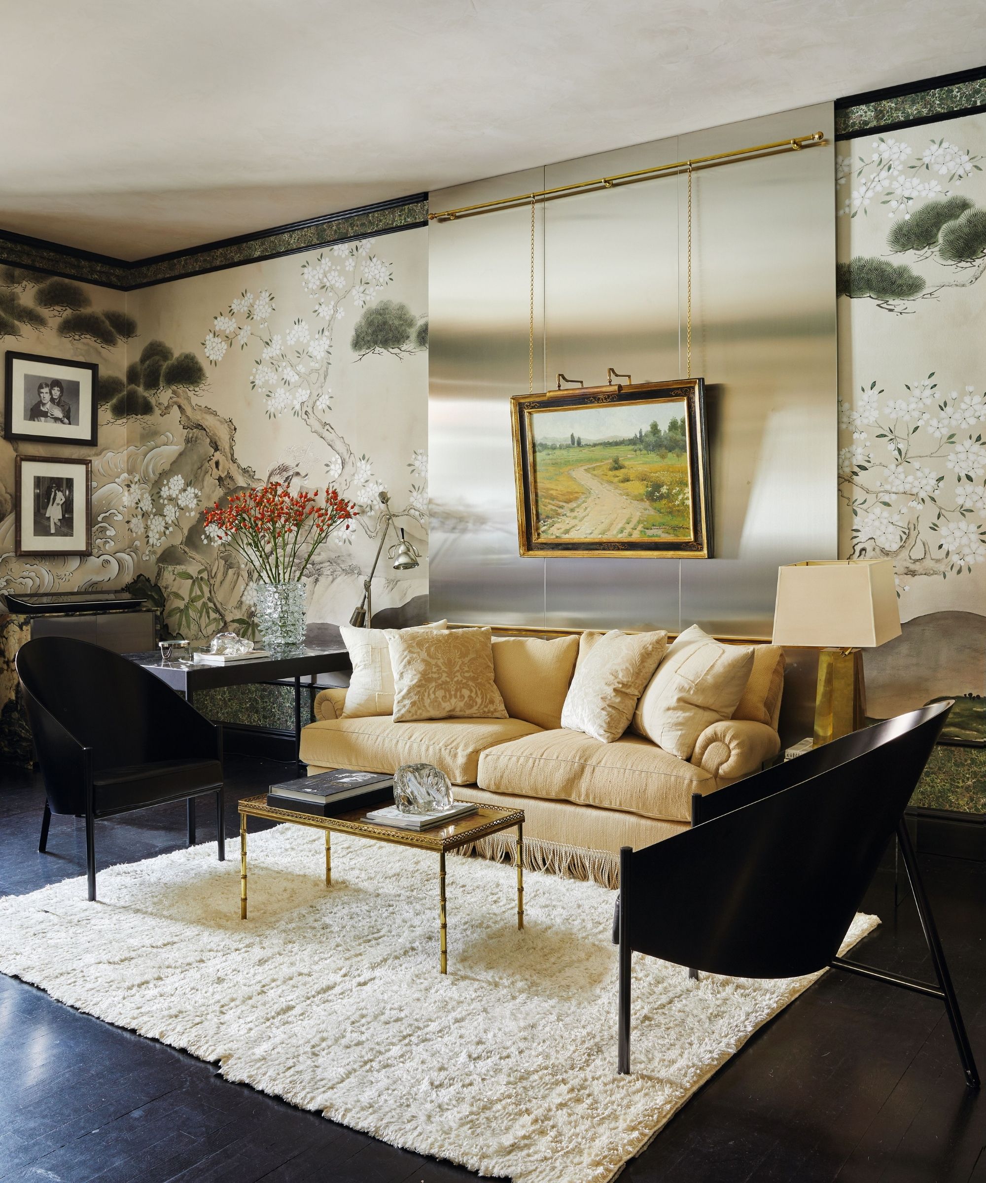 a mural wrapped sitting room in a new york apartment with a stainless steel wall panel with yellow sofa with fringe trim