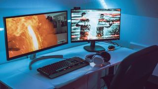 Big gaming computer set up with headset and two screens. There is an empty chair. Nobody is there and the screens show live streaming of an esport event.