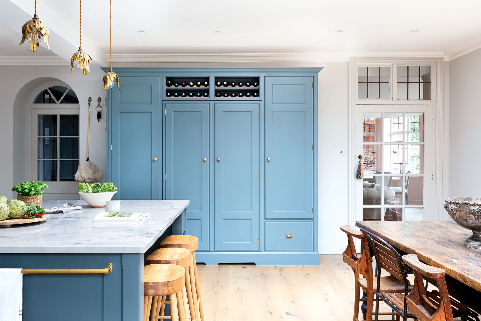Characterful spacious kitchen diner with Georgian bespoke carpentry in bright blue, storage and a kitchen island