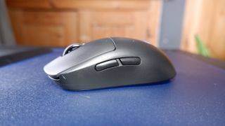 A Logitech G Pro wirless gaming mouse on a mouse pad