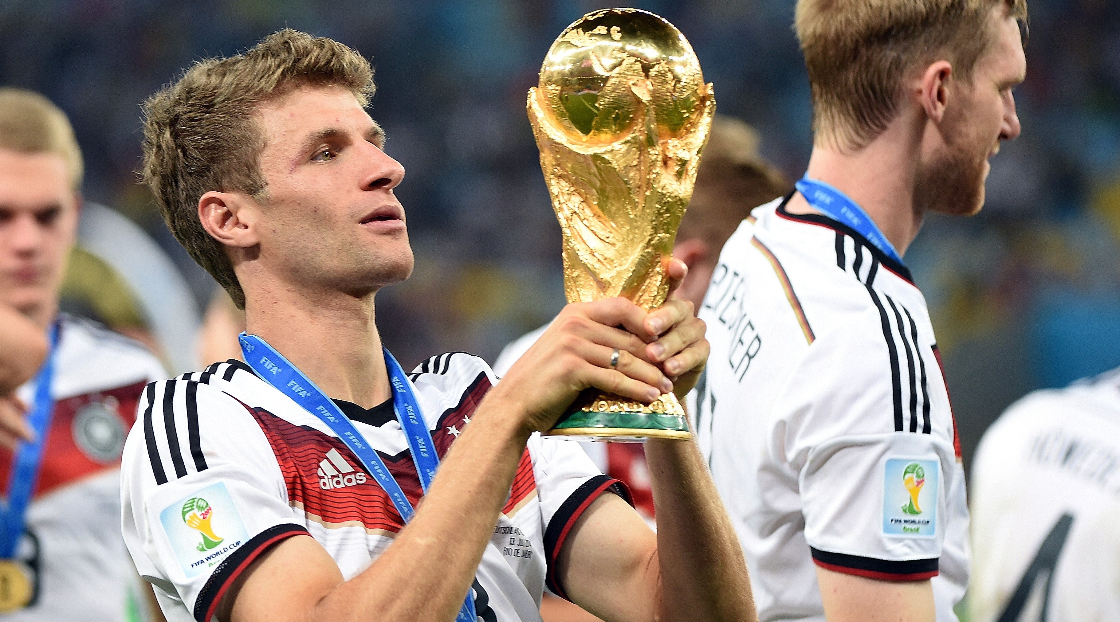 Germany's forward Thomas Mueller holds the World Cup trophy after winning the final football match between Germany and Argentina for the FIFA World Cup at The Maracana Stadium in Rio de Janeiro on July 13, 2014. AFP PHOTO / PATRIK STOLLARZ (Photo credit should read PATRIK STOLLARZ/AFP via Getty Images)