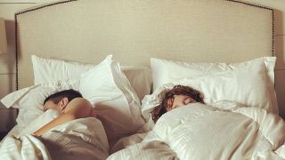 Two people sleeping in bed