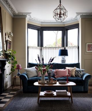 living room with glass and metal angular pendant light, large sofa and coffee table