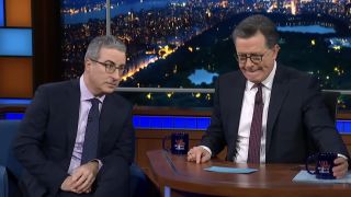John Oliver guesting on The Late Show next to Stephen Colbert