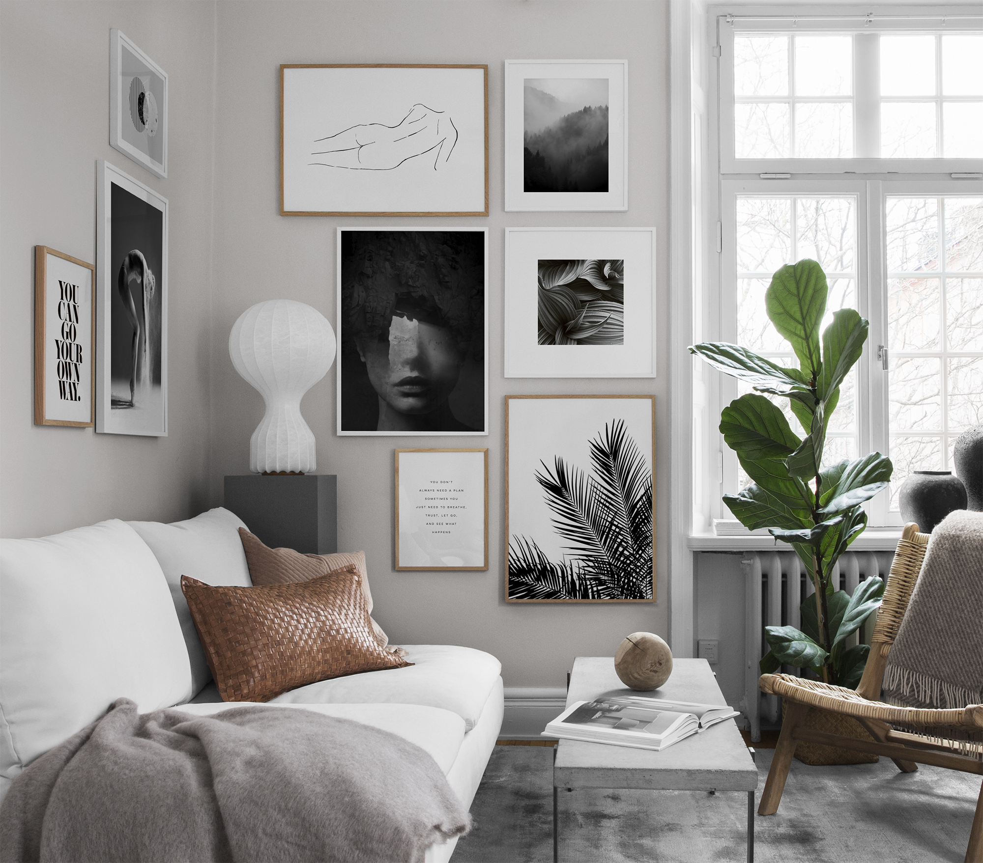 A modern living room idea by Desenio with a gallery wall and tall houseplant