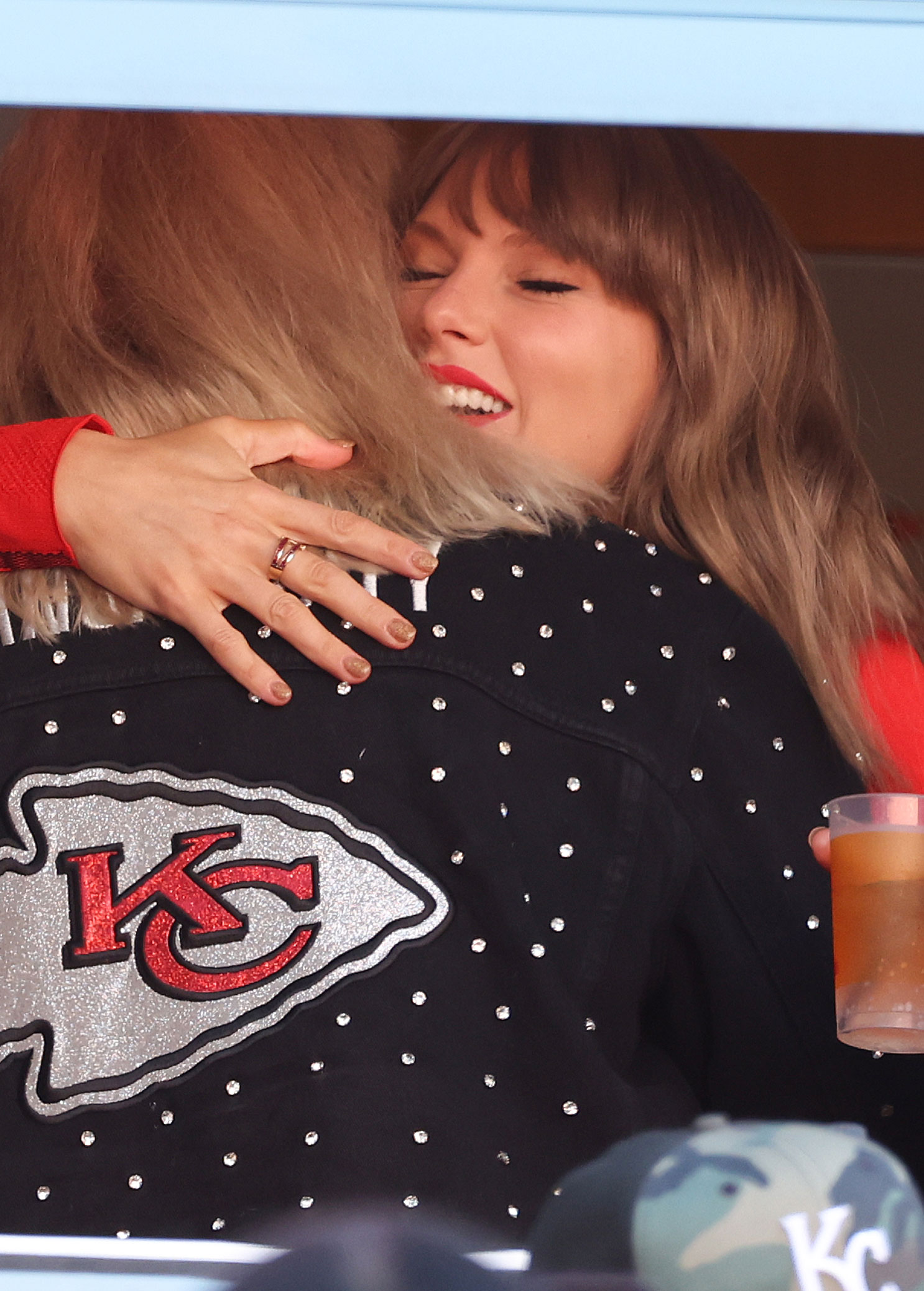 Taylor Swift wears a red turtleneck and a ruby ring at a Kansas City Chiefs game.