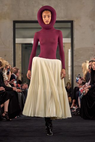 Alaïa Summer Fall 2025 runway show at Paris Fashion Week A/W 2025 featuring Mona Tougaard in hooded gown