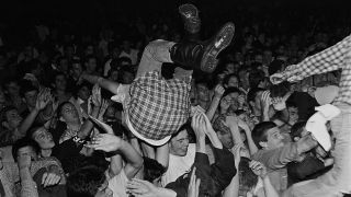 A crowd-surfer at a Fear show in 1982