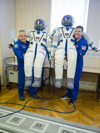 NASA astronaut Jack Fischer (right) and Roscosmos cosmonaut Fyodor Yurchikhin pose for a picture with their Sokol spacesuits at the Integration Building of Baikonur Cosmodrome on April 6, 2017 ahead of an April 20 launch.