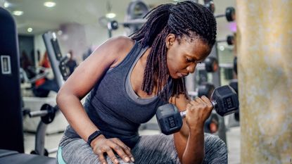 Woman performing a dumbbell arms workout