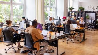 Employees working in open plan office